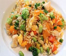Fried rice with vegetables and chicken served on a plate, highlighting the best of Indian and Nepali restaurant offerings.