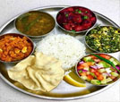 An assortment of Indian and Nepali foods on a plate, highlighting the exceptional culinary experience from a leading restaurant.