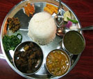 An assortment of four distinct food items on a plate, representing the best of Indian and Nepali culinary traditions.