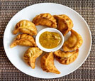 A plate filled with assorted dumplings, showcasing the culinary delights of Indian and Nepali cuisine.