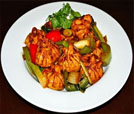 A colorful dish of Indian and Nepali food, artfully arranged with vegetables and meat, ideal for restaurant and catering services.