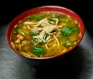 A bowl of flavorful soup filled with noodles and fresh vegetables, showcasing Indian and Nepali culinary excellence.