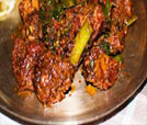 A vibrant plate featuring succulent meat and fresh vegetables, showcasing the best of Indian and Nepali cuisine.