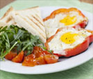 A delicious serving of eggs in a medley of peppers and tomatoes on a plate, reflecting the essence of Indian and Nepali food.
