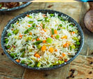 A fork rests beside a plate of rice and vegetables, highlighting the exquisite offerings of Indian and Nepali cuisine.