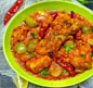 A green bowl brimming with colorful stew and vegetables, showcasing the essence of Indian and Nepali cuisine.