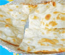 Close-up of a tortilla nestled in a tin foil pan, showcasing the restaurant's culinary offerings.