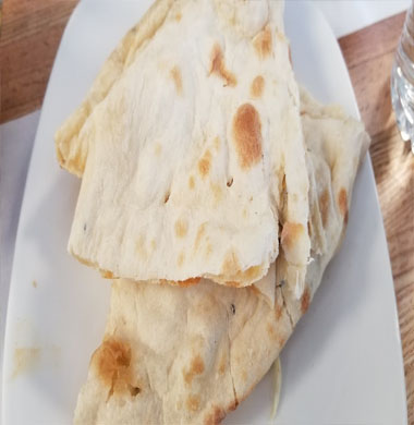 Two flatbreads elegantly arranged on a plate, representing the culinary excellence of Indian and Nepali dishes.