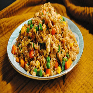 Delicious fried rice adorned with fresh vegetables and meat, representing the best of Indian and Nepali cuisine.